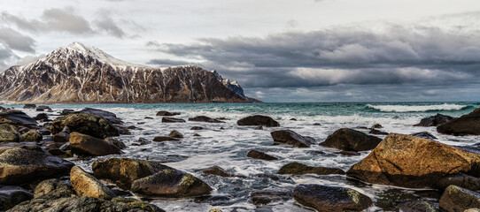 Fototapeta na wymiar Magnificent winter mountain landscape on the sea. Vareid beach, Lofoten islands, Norway.
