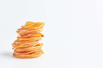 slices dried oranges, grapefruits, tangerines or citrus fruits on top of each other on a white background. copy space.