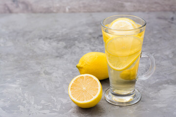 Refreshing lemon drink on the table. Alternative medicine, treatment with folk remedies.
