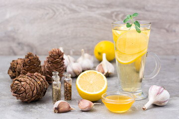 Set of natural antiviral agents: lemon, garlic, honey, herbs, cedar resin on the table. Alternative medicine. Immunity Care