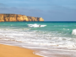 Surfer on his board sporting in the ocean