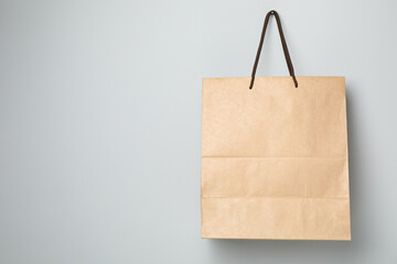 Empty paper bag on gray background, space for text.