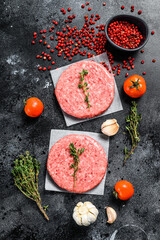 Raw mince meat cutlet, ground beef and pork. Burger patties. Black background. Top view