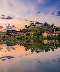 Fototapeta na wymiar Reflection of Sevnica over Sava river, Slovenia.