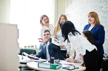 Portrait of caucasian woman in white blouse against business people group of bank workers have meeting and working in modern office.