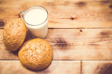 Fresh bun with sesame seeds and a cup of milk. 