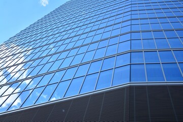 Facade texture of a glass mirrored office building. Fragment of the facade. Modern architecture of the office building.