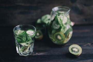 Detox drink, infused water, homemade refreshing kiwi and cucumber green lemonade. Tasty healthy vitamin beverage