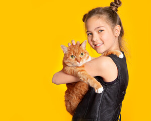 Cute European teen girl and red cat. A child and a cat on a yellow background. Pets, care for the animals. Cat care, veterinary medicine, animal feed.