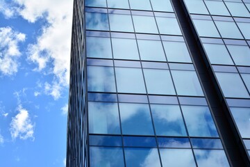 Facade texture of a glass mirrored office building. Fragment of the facade. Modern architecture of the office building.