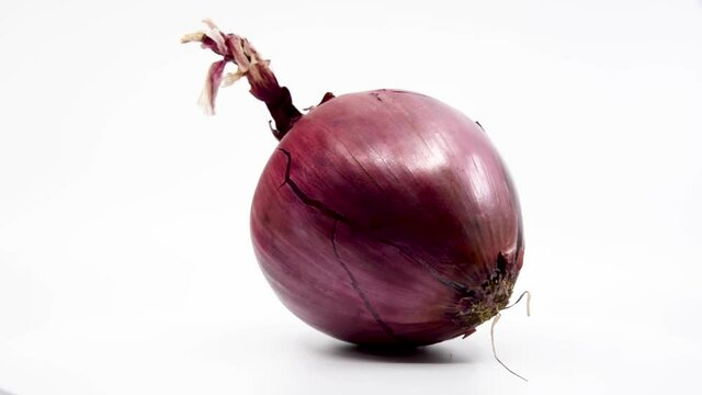 Red onion spinning with a white background. 