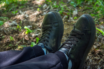 Top view close up of woman's sneakers in nature