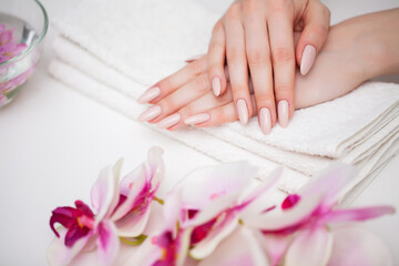 Woman demonstrates a fresh manicure made by a beauty studio