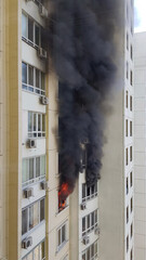 Burning fire with black smoke from windows of building. Accident due arson in protests