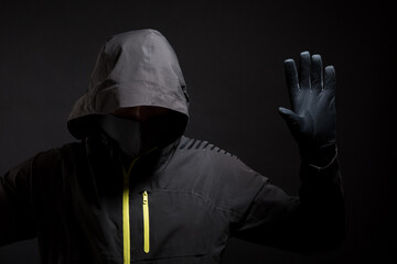 Unknown, indistinguishable thug or hucker in handcuffs and black clothes is arested. Concept: Crime...