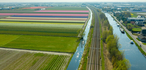 Aerial view of dutch village, canals, railway road and tulip bulb fields