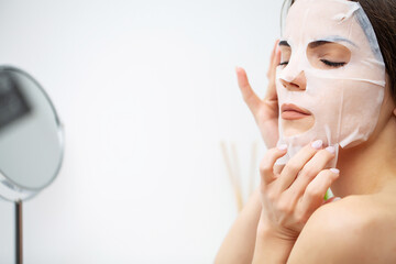 A woman uses a moisturizing mask to take care of her skin