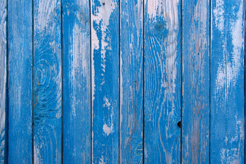 Fototapeta na wymiar Old blue painted wood wall. Vintage background. Texture of shabby wooden planks with peeling blue paint, rustic wooden house. Picture for wallpapers.