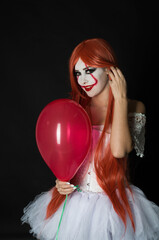 a girl in a clown costume with scary makeup