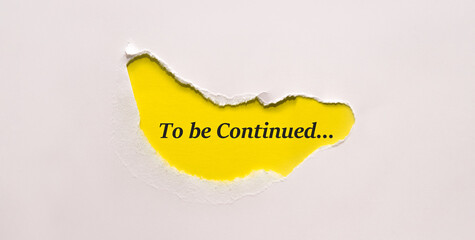 Torn green paper revealing the words to be continued