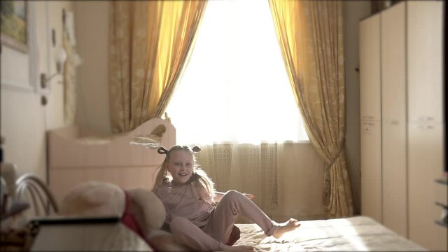 Bear Teddy hugs the girl and jumps high to the ceiling with her