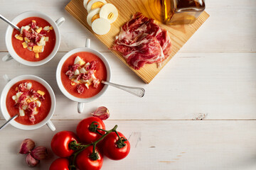 Tomato soup, salmorejo, with raw ingredients on a table, copy space