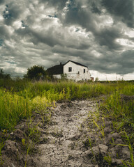 Old rundown house with storm clouds overhead