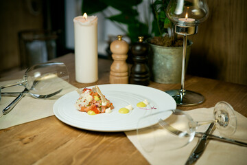 Salmon tartare with red caviar and croutons .On a white plate. On a restaurant background