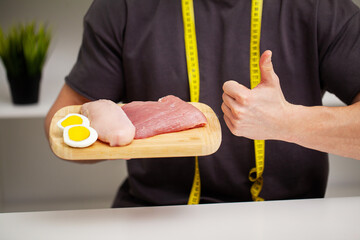 A man holds food with a high protein content for proper nutrition