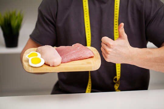 A man holds food with a high protein content for proper nutrition