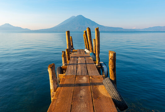 Sunrise by the Atitlan Lake with an embarkation pier, Panajachel, Guatemala. - Powered by Adobe