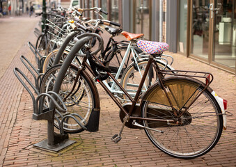 Obraz premium Bicycle parking on the street. A lot of old bikes, locked at parking