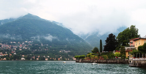 Panoramic view of Como lake with villages and mountains shrouded in clouds. Torno. Italy.