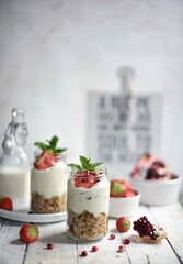 Fresh strawberries , yogurt and homemade granola for healthy breakfast on white background, selective focus.
