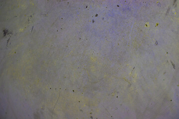 The texture of the scratched cement in a delicate yellow-blue hue. There is a place for text. The photo was made close-up for your urban design.