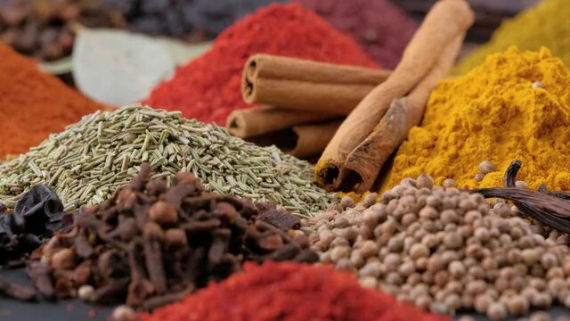 Various fragrant spice market. Heap different Indian Spices rotated on wooden table. Assortment spices and herbs for cooking