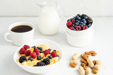 Healthy breakfast with cornflakes, berries and nuts