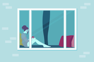 The girl is sitting at home and reading a book. View through the window. Cozy lounger near the window with pillows. Plastic window on a brick wall