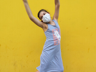 little girl with face mask jumping