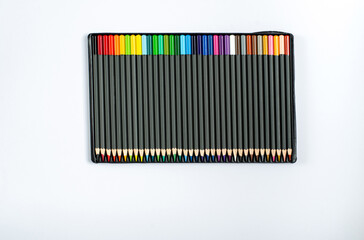 Colored pencils in a case on a white background