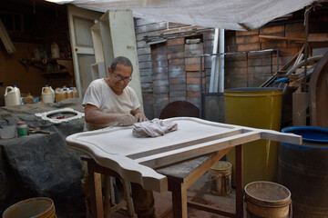 Mature latin man working the wood