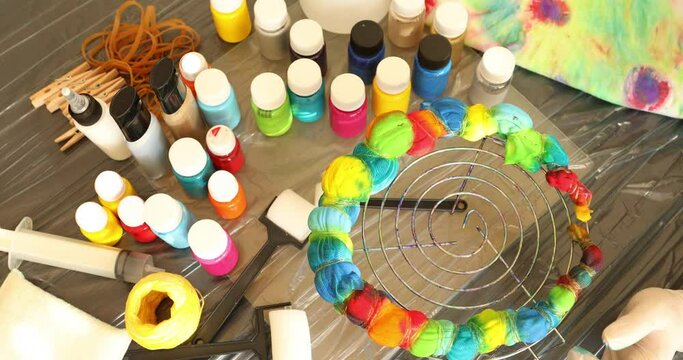 Woman applying tie dye technique to t shirt
