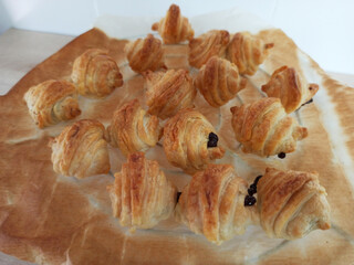 Small croissants filled with chocolate, freshly baked. Baked pastries. French pastry