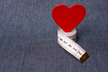 Heart shape and measuring tape. Valentine concept and promise of love.