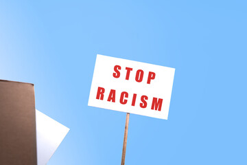 Stop racism. Holding up a banner with a powerful anti-racist message.