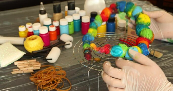 Woman applying tie dye technique to t shirt