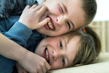 Two children boy and girl fooling around having fun together. Happy childhood concept.