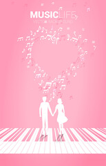 Lover couple holding hand standing on piano key with music melody note dancing flow . Concept background for love song and concert theme.