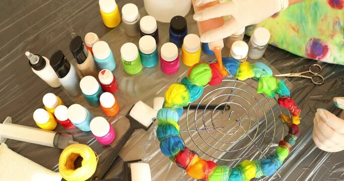 Woman applying tie dye technique to t shirt