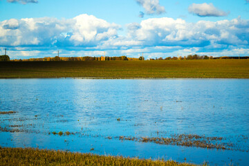 Landscape of the valley in Europe, Cloudy sky and autumn colors, water reflection.
